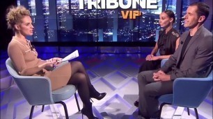 French TV show host in black pantyhose and boots